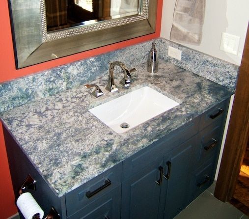 A bathroom vanity with a sink and a mirror