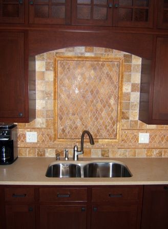 A kitchen with two sinks and a coffee maker