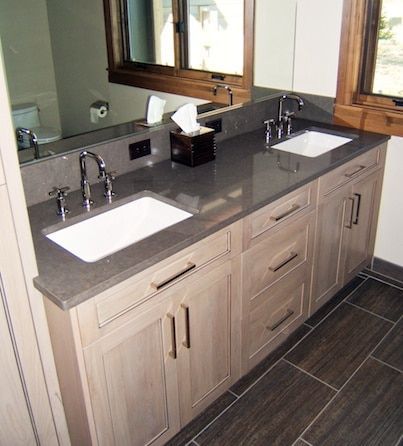 A bathroom with two sinks and a mirror