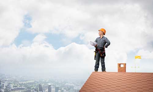 A man on top of a new roof