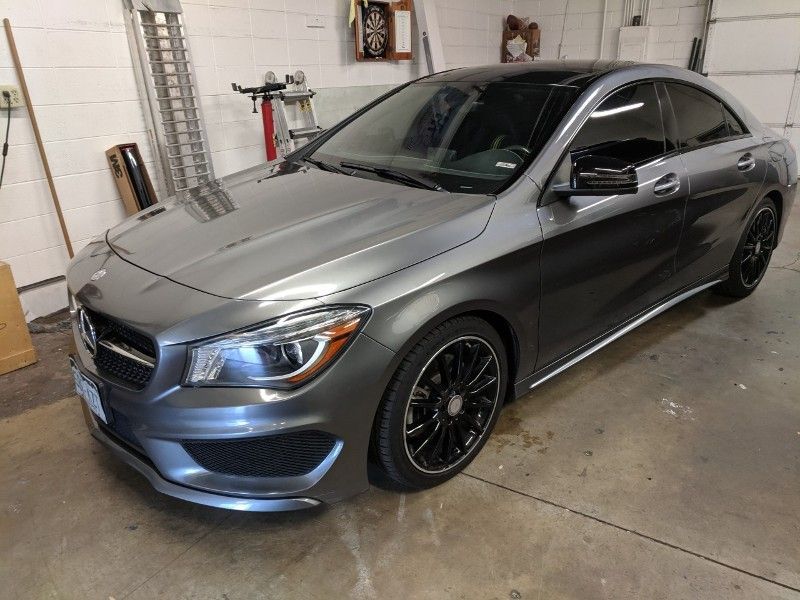 A mercedes benz cla 45 amg is parked in a garage.