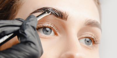 woman getting eyebrows groomed