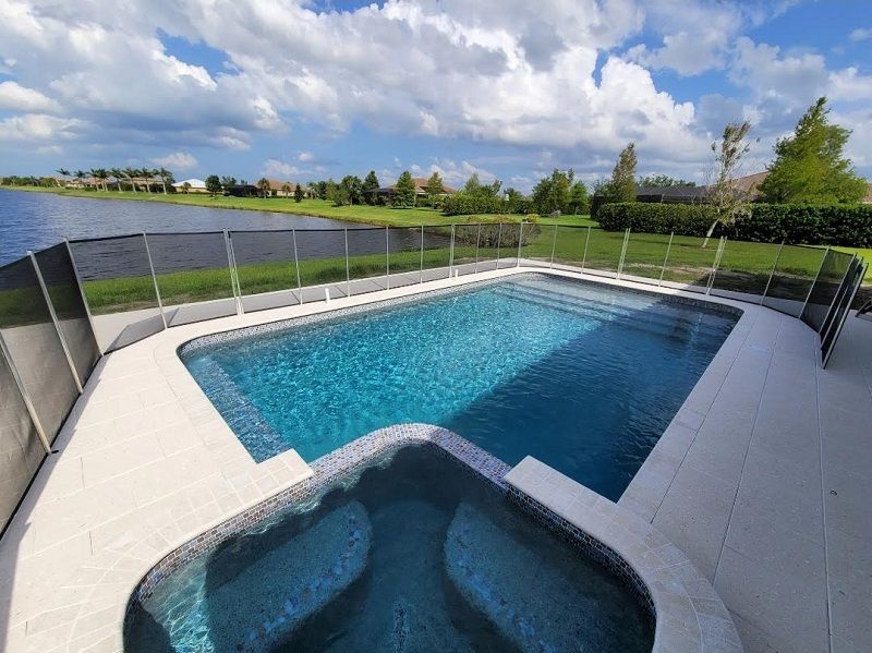 A large swimming pool with a fence around it