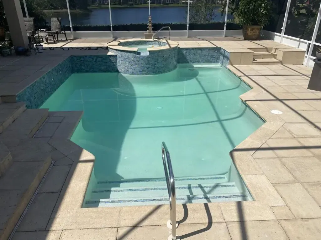 A large swimming pool with stairs leading to it