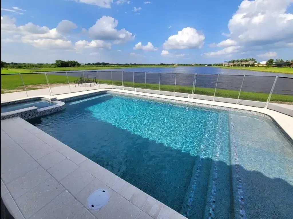 A large swimming pool with a view of a lake