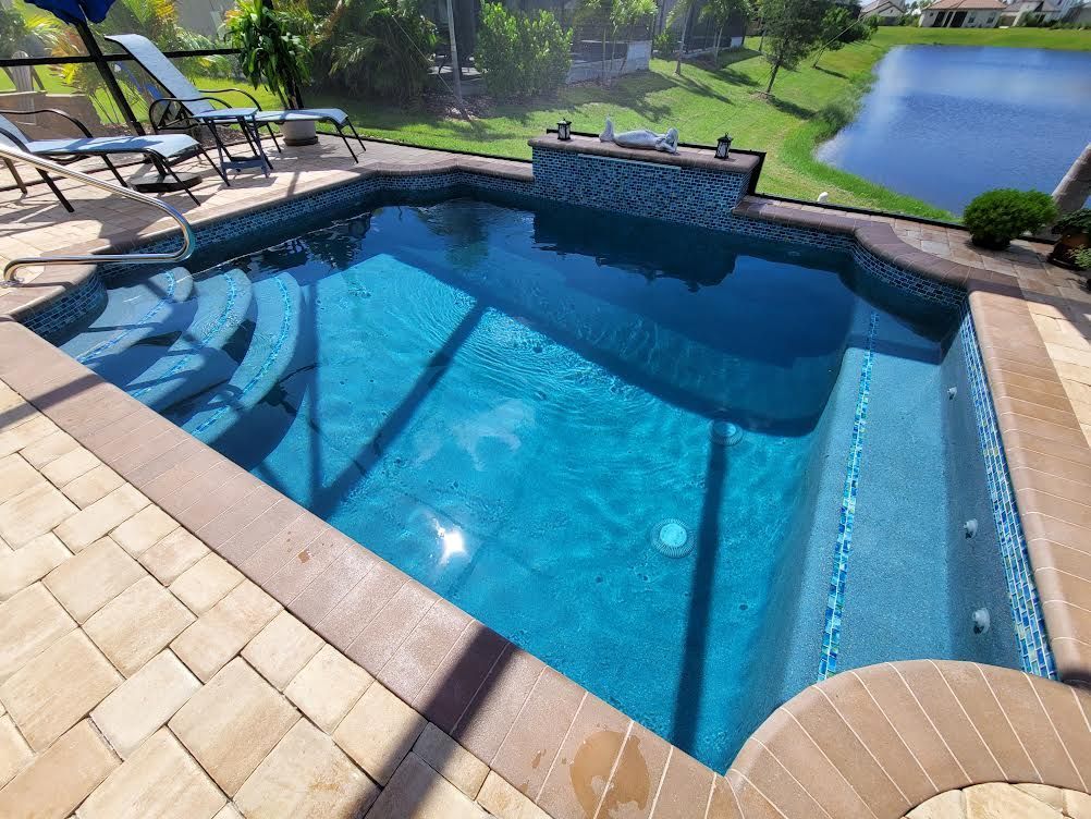 A large swimming pool with a view of a lake