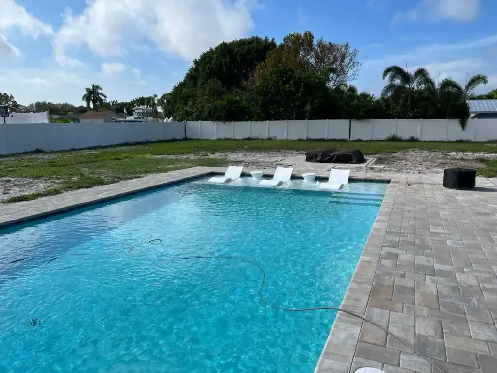 A large swimming pool with a blue sky in the background