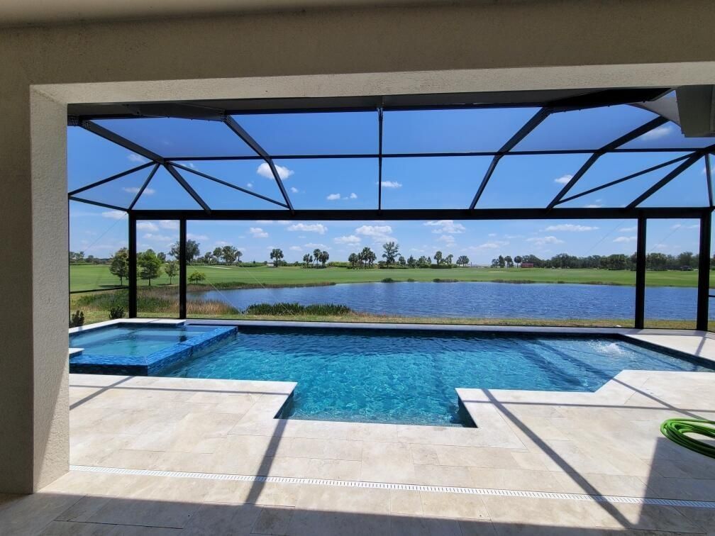 A large swimming pool with a view of a lake