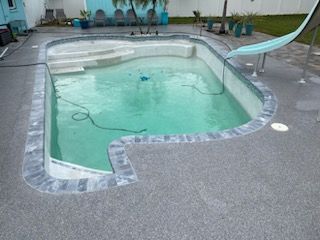 A large swimming pool with stairs leading to it.