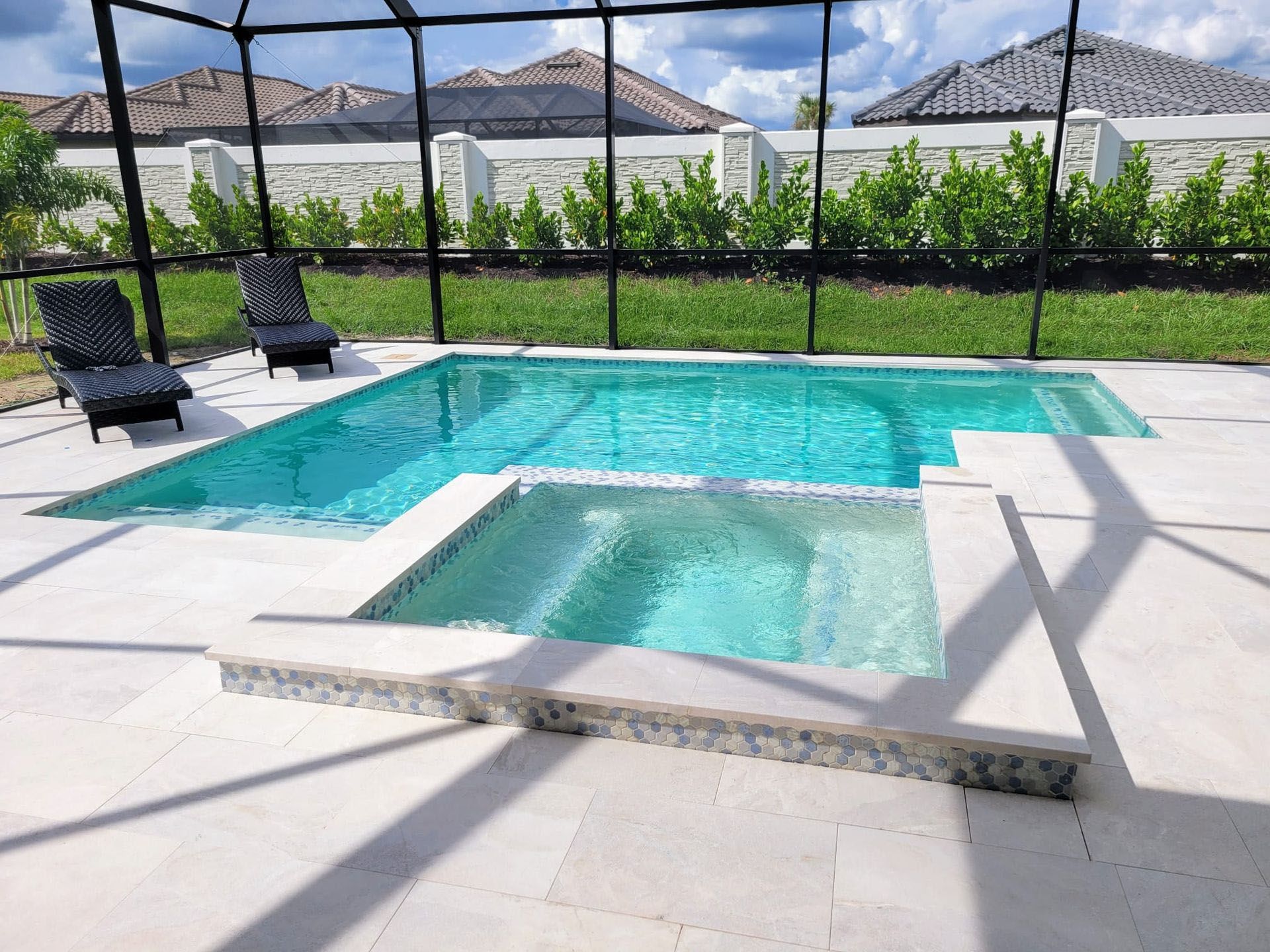 A house with a large swimming pool in front of it.