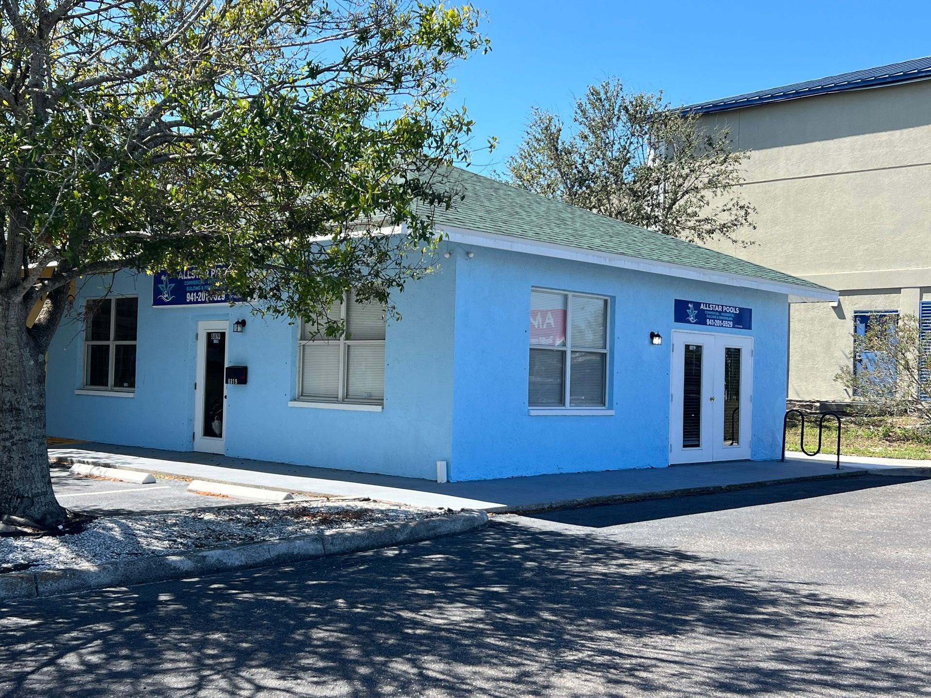A large room with a lot of furniture and paintings on the wall.