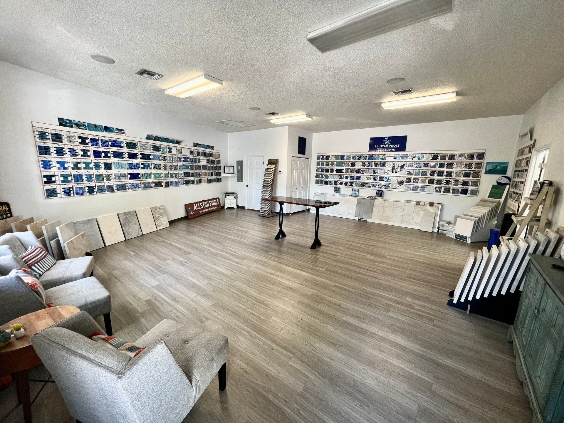 A large room with a lot of furniture and paintings on the wall.