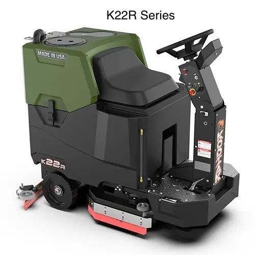 A green and black machine with a steering wheel is sitting on a white surface.