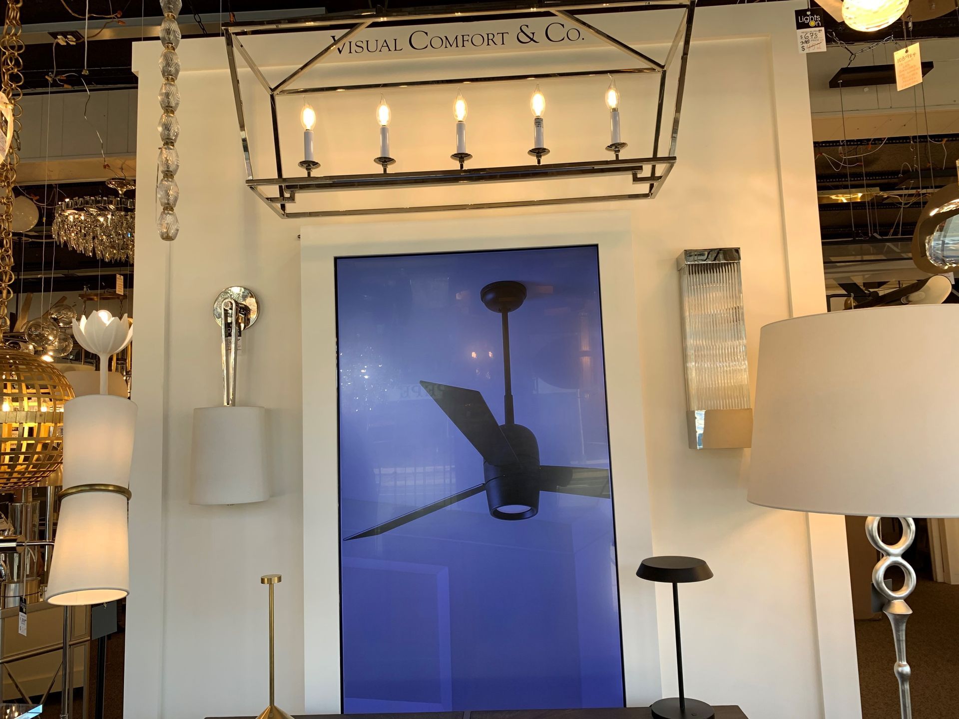 A table with two vases on it in a room with mirrors