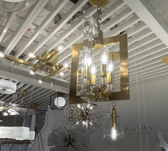 A kitchen with a large island , stools and a stove.