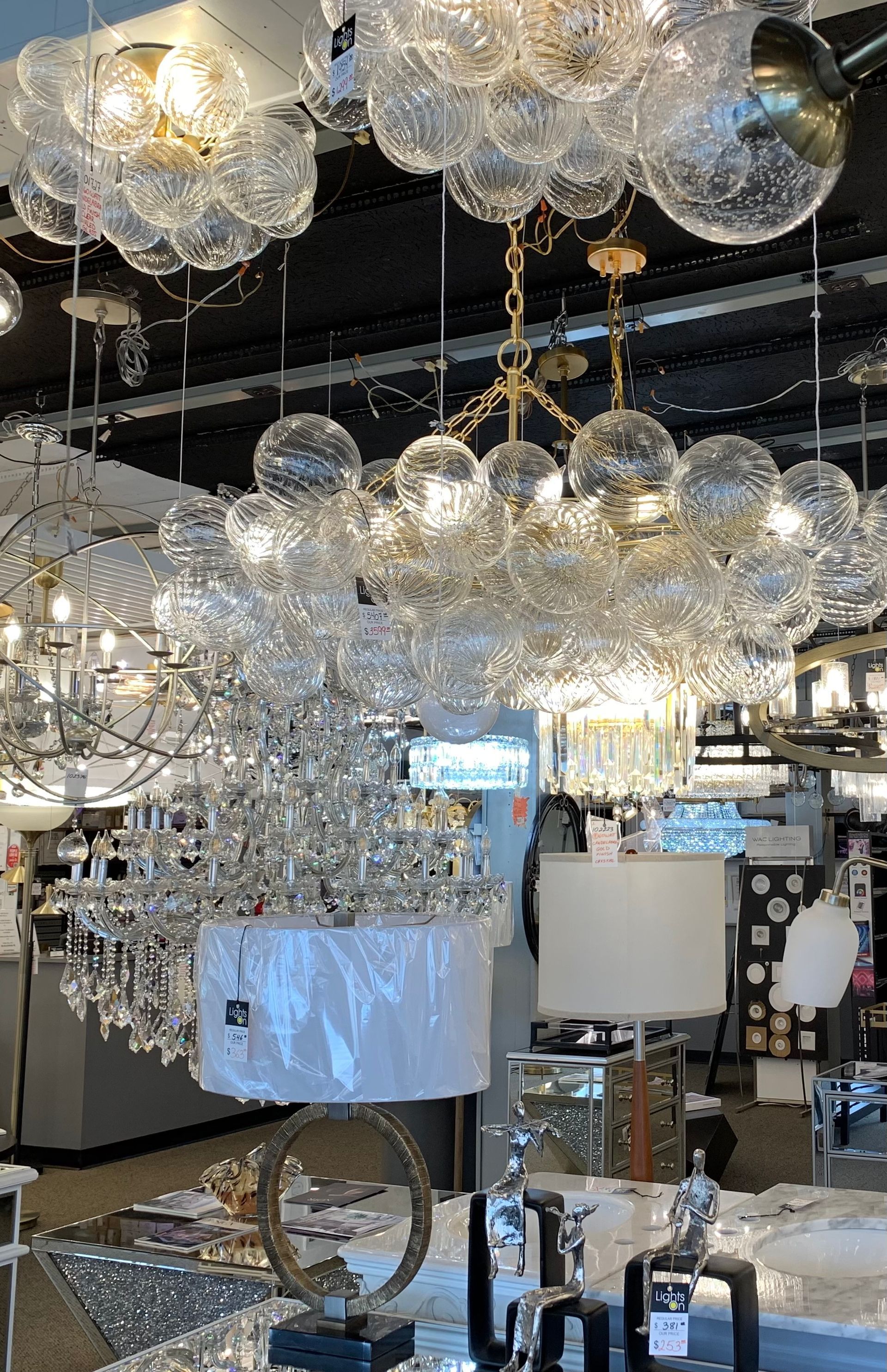A store filled with lots of chandeliers and lamps.
