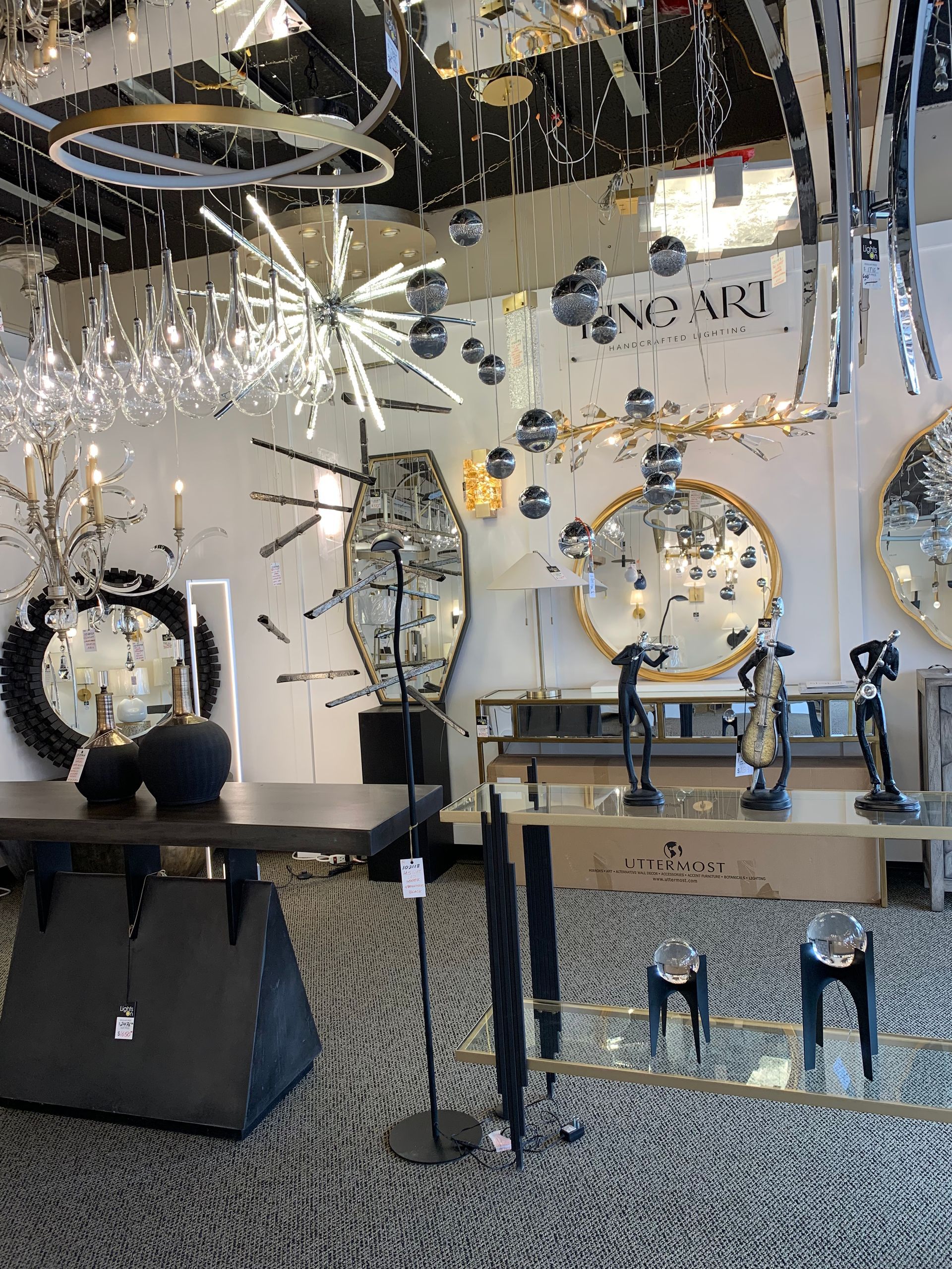 A room filled with lots of mirrors and lamps.