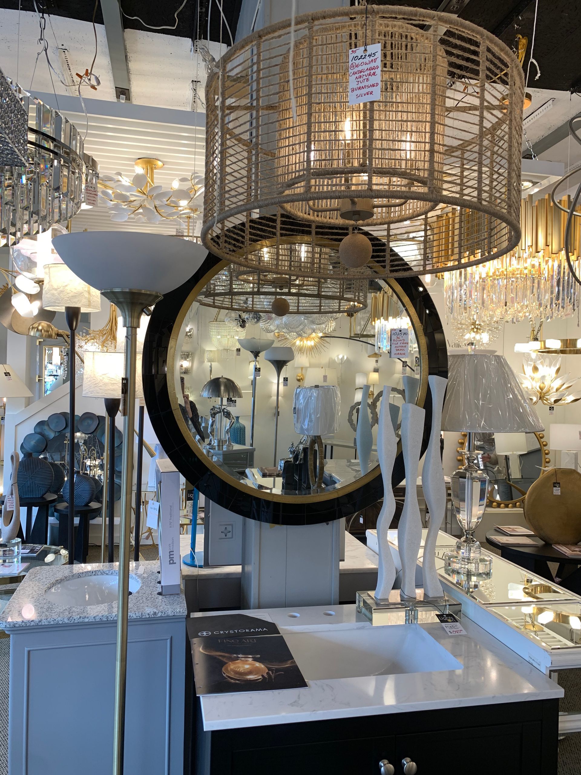 A bathroom with a sink and a mirror in a store.