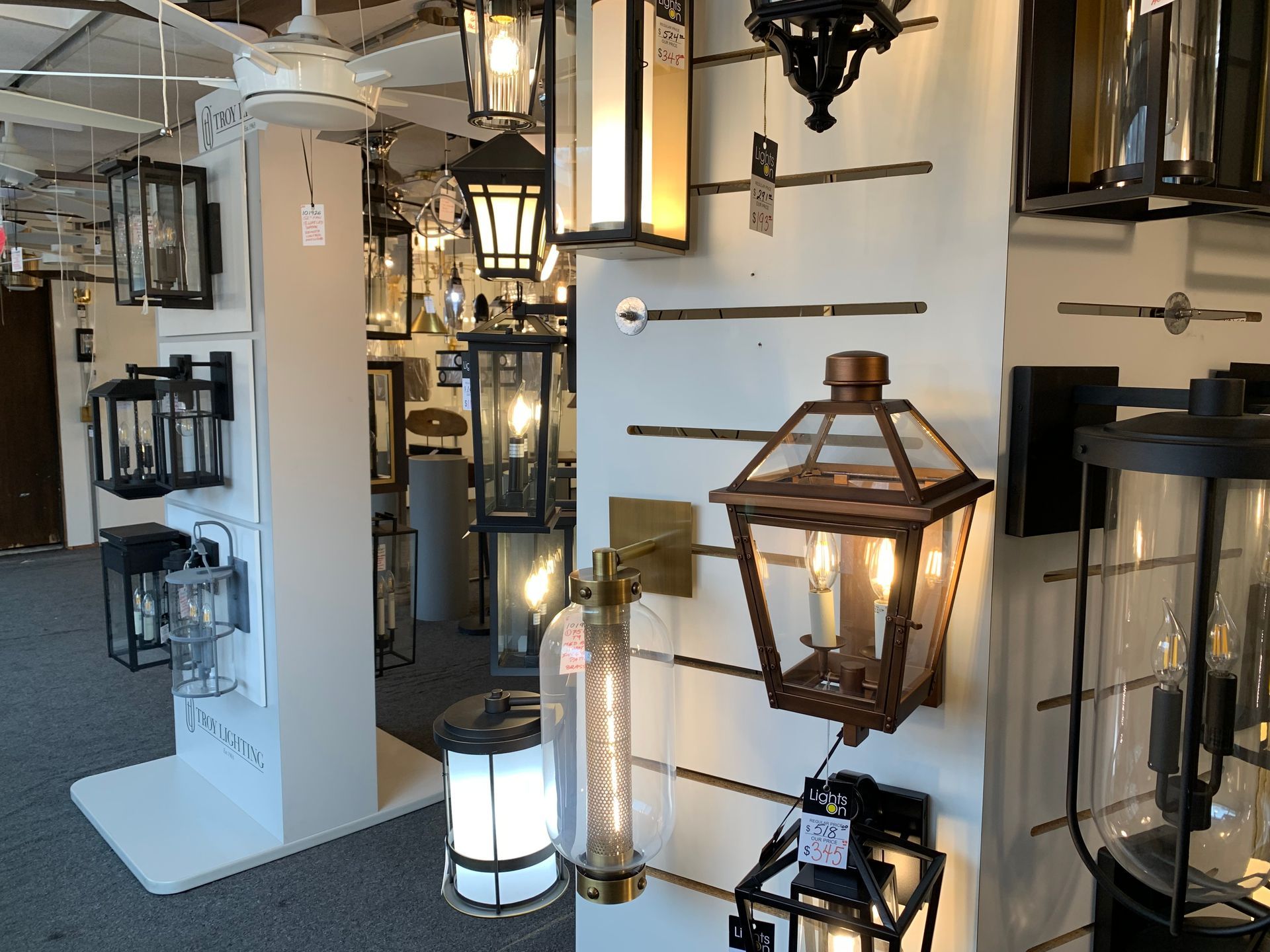 A display of lanterns on a wall in a store.