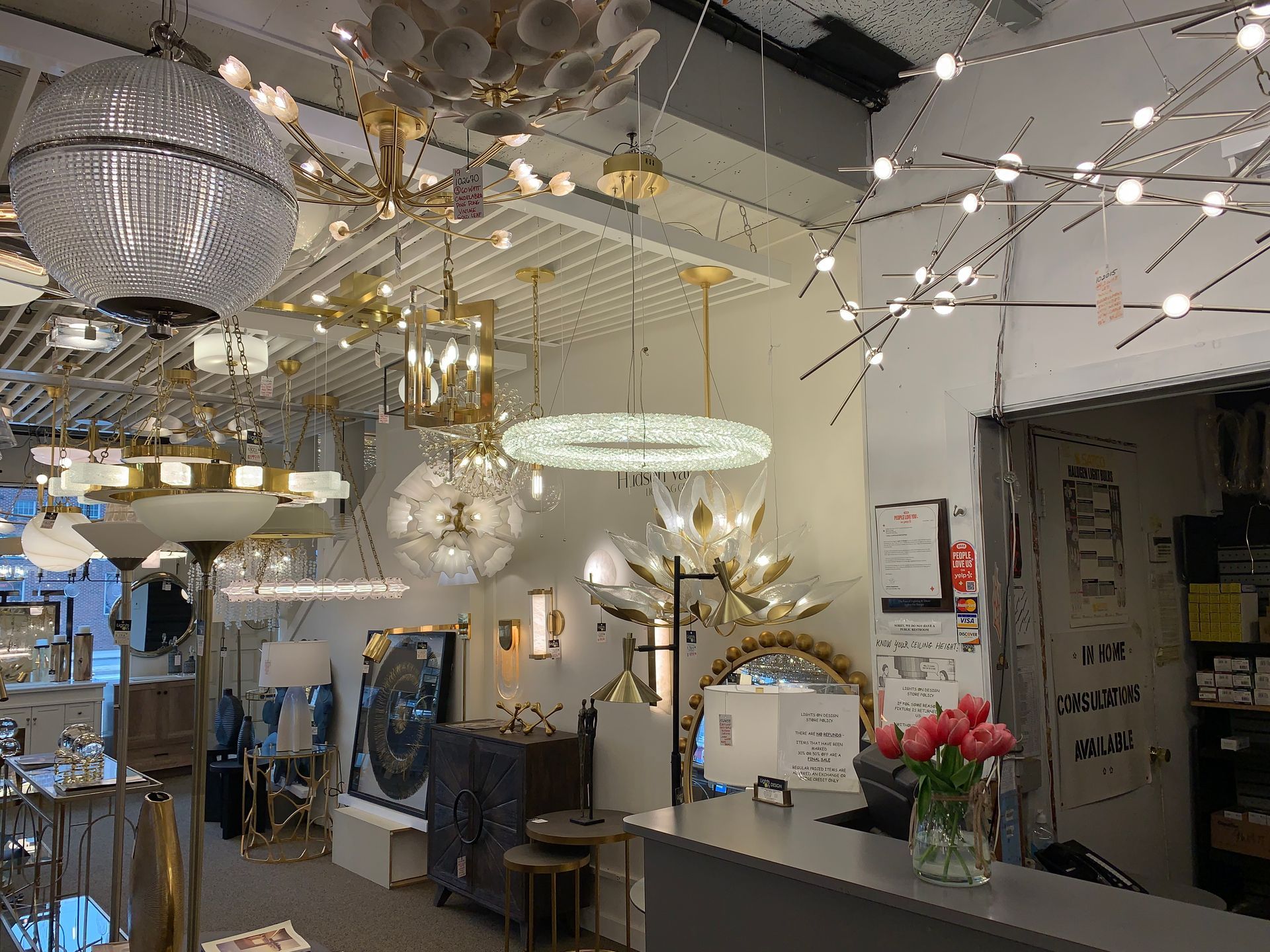 A store filled with lots of lights and a vase of flowers.