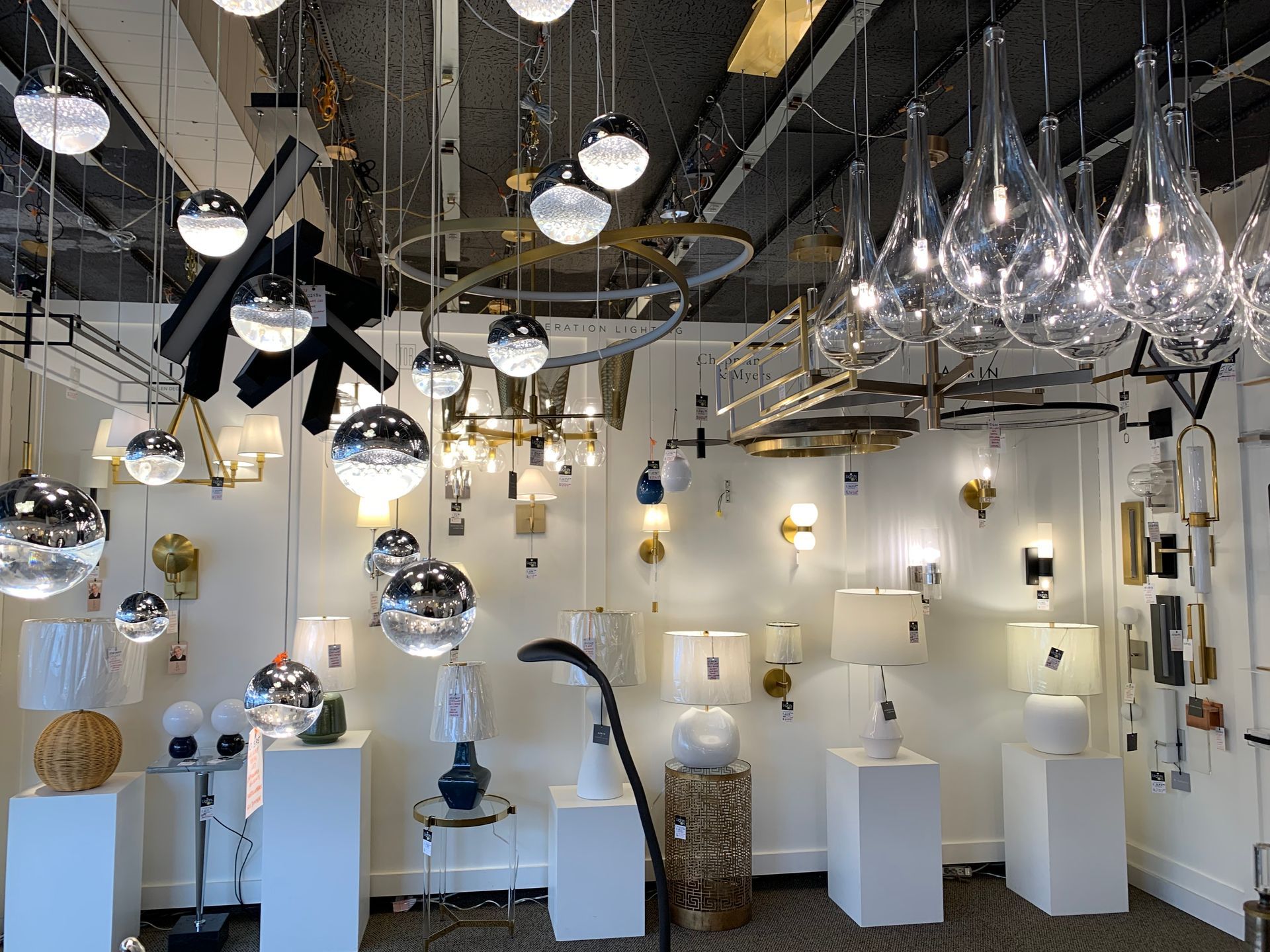 A room filled with lots of lights and lamps hanging from the ceiling.