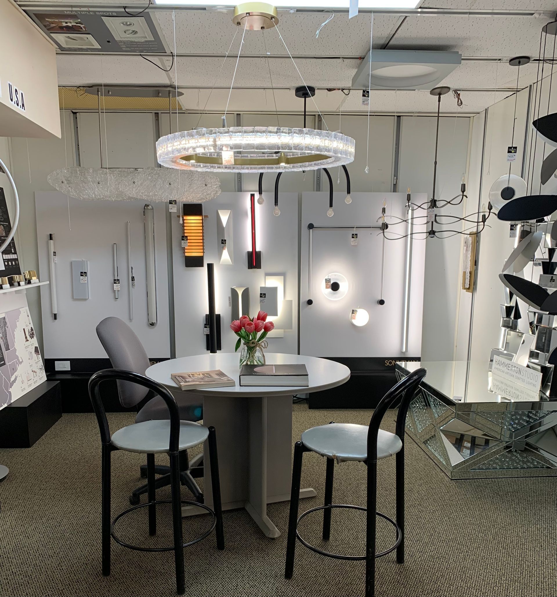 A room with a table and chairs and a chandelier hanging from the ceiling