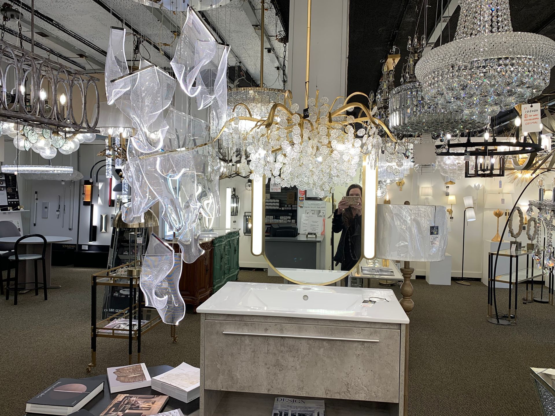 A woman is taking a picture of herself in a bathroom in a store.
