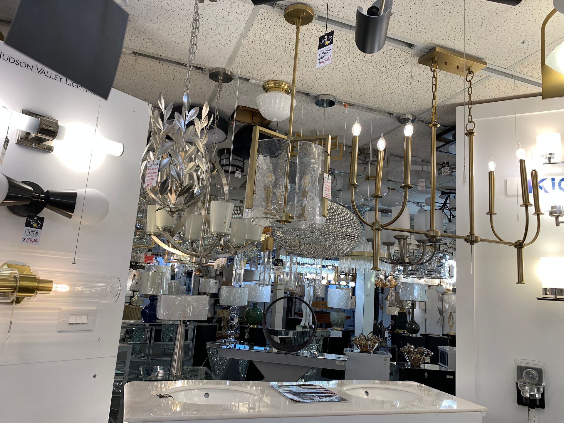 A store filled with lots of chandeliers and lamps