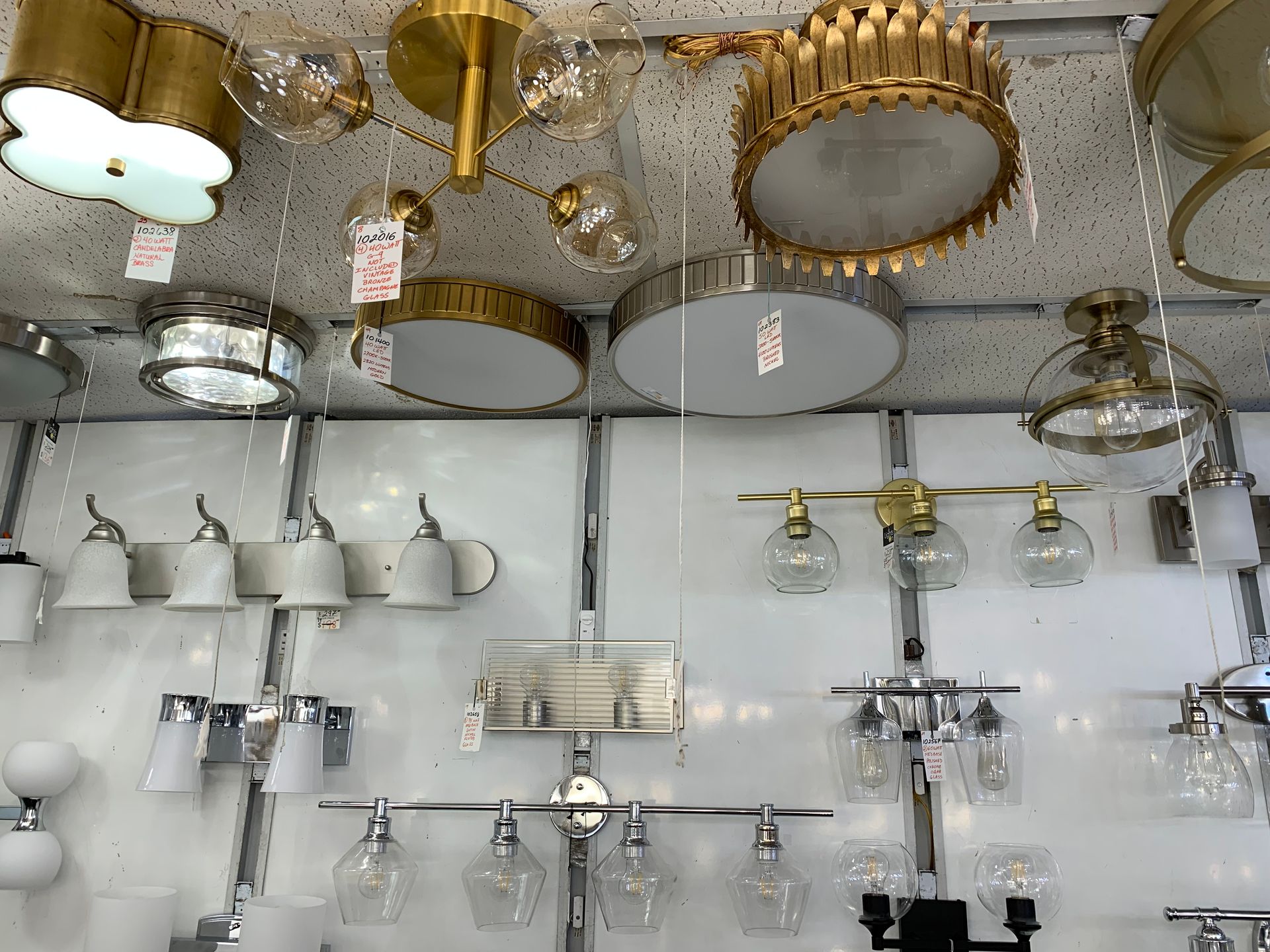 A bunch of lights are hanging from the ceiling in a store