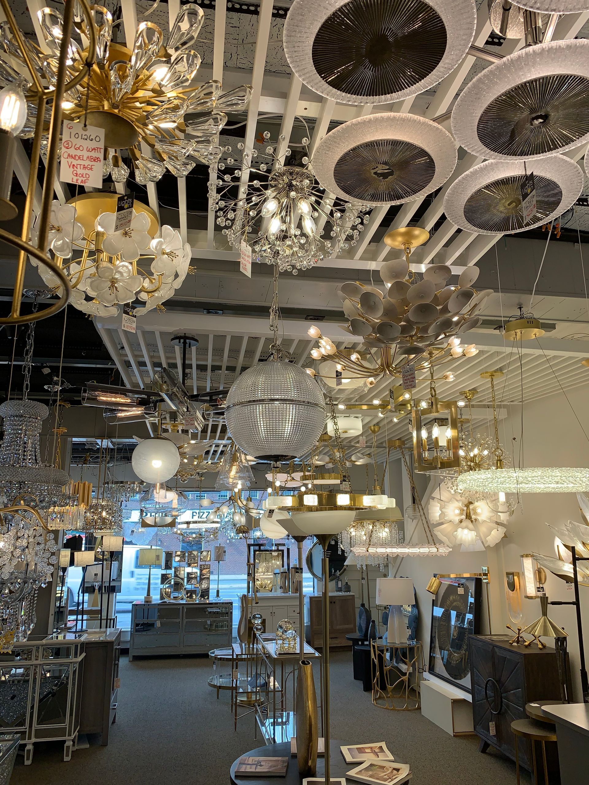 A store filled with lots of chandeliers and lamps.