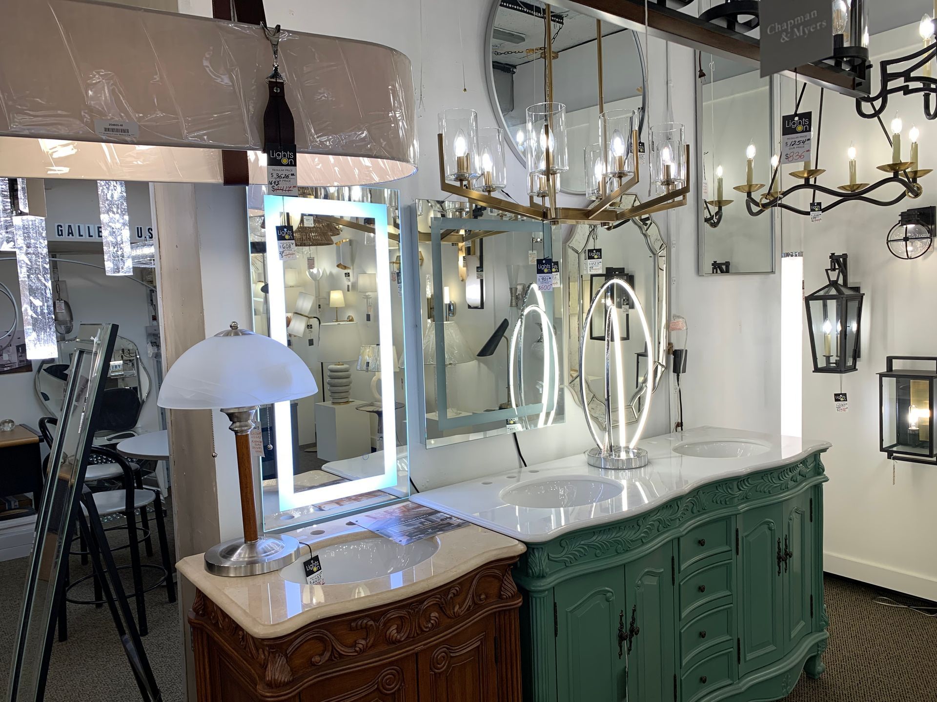 A bathroom with two sinks , a mirror and a lamp.