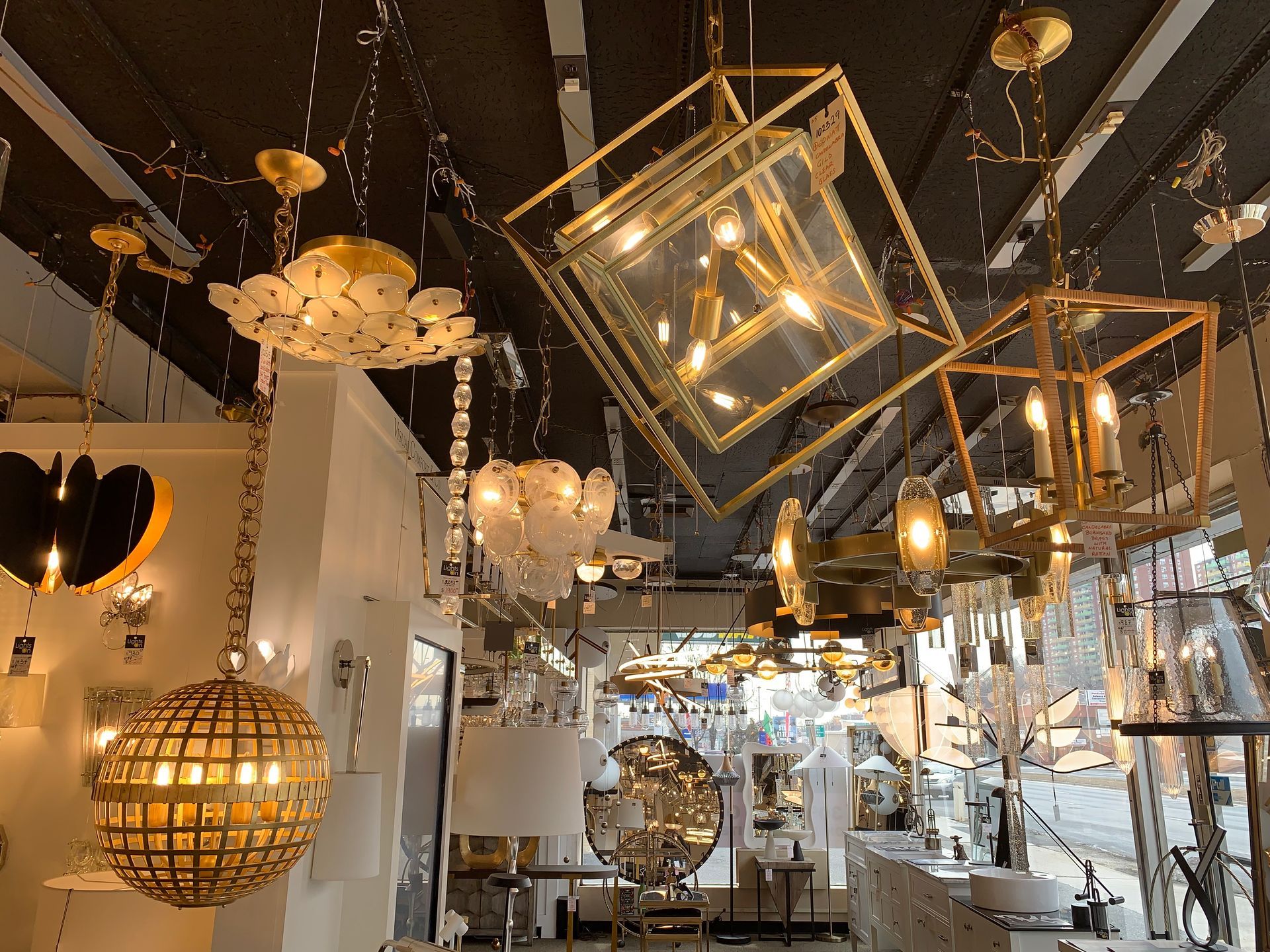 A store filled with lots of lights hanging from the ceiling.