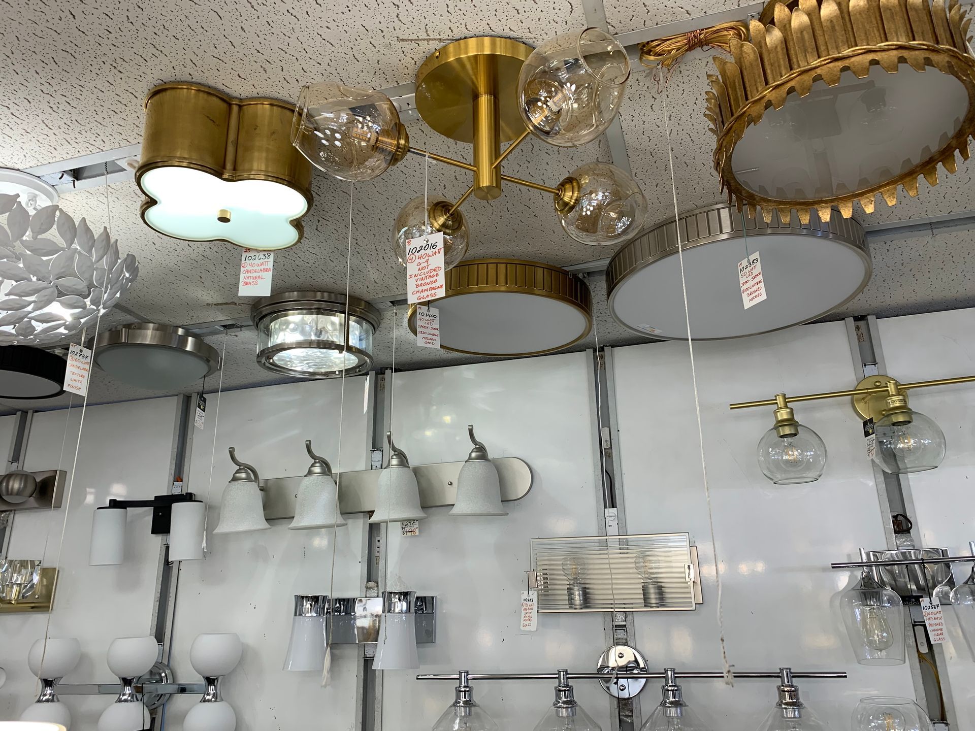 A bunch of lights are hanging from the ceiling in a store