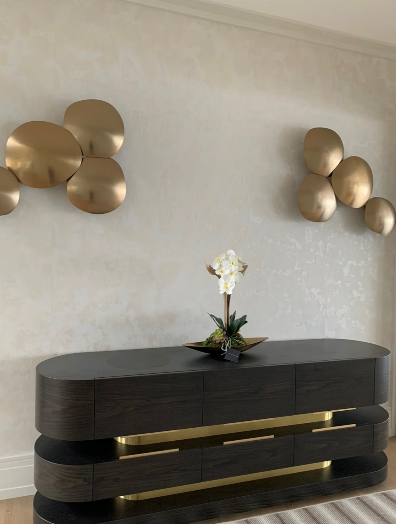 A dresser with a vase of flowers on top of it.