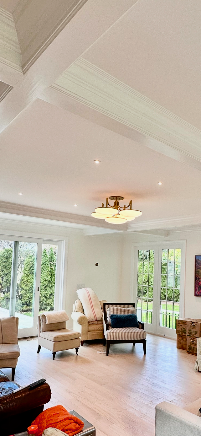 A living room filled with furniture and a chandelier.