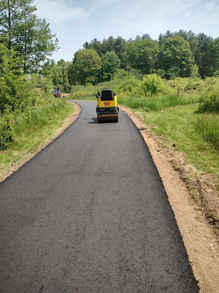 A yellow truck is driving down a curvy road