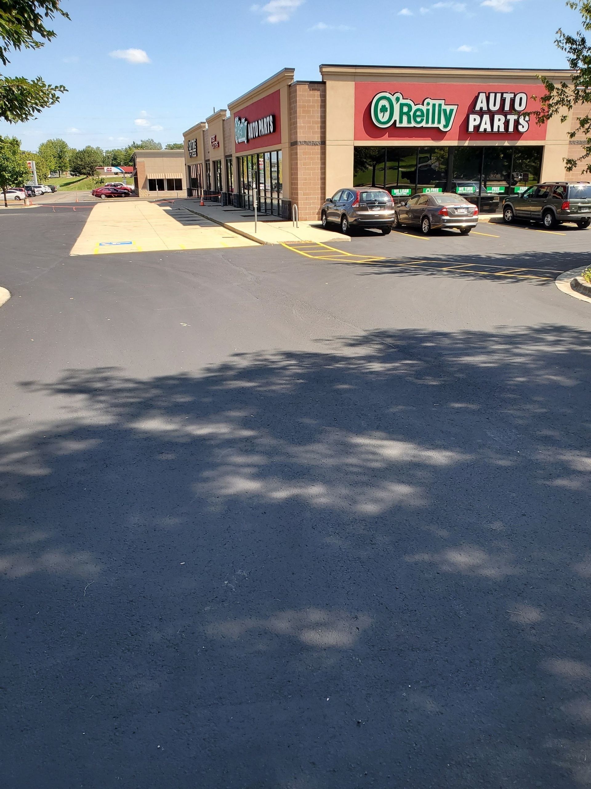 A shelby auto parts store with cars parked in front of it