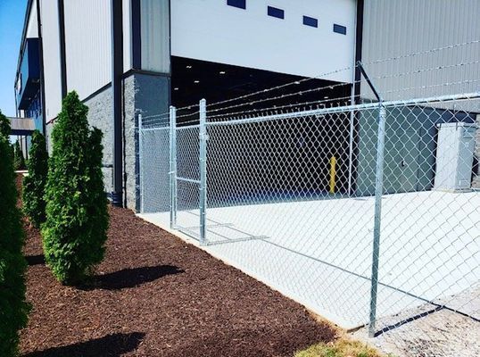 A chain link fence is in front of a building