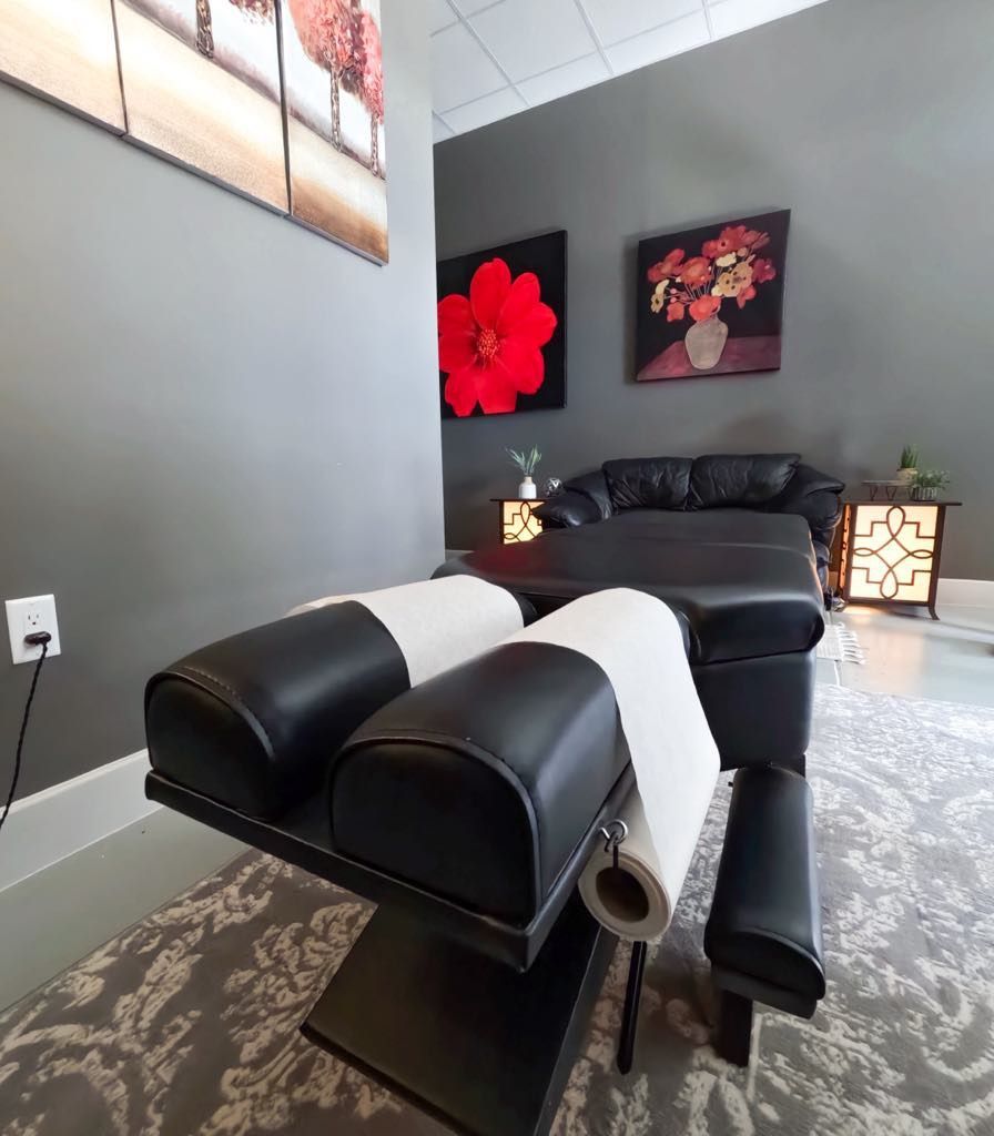 A room with a couch and a table with a roll of paper towels on it