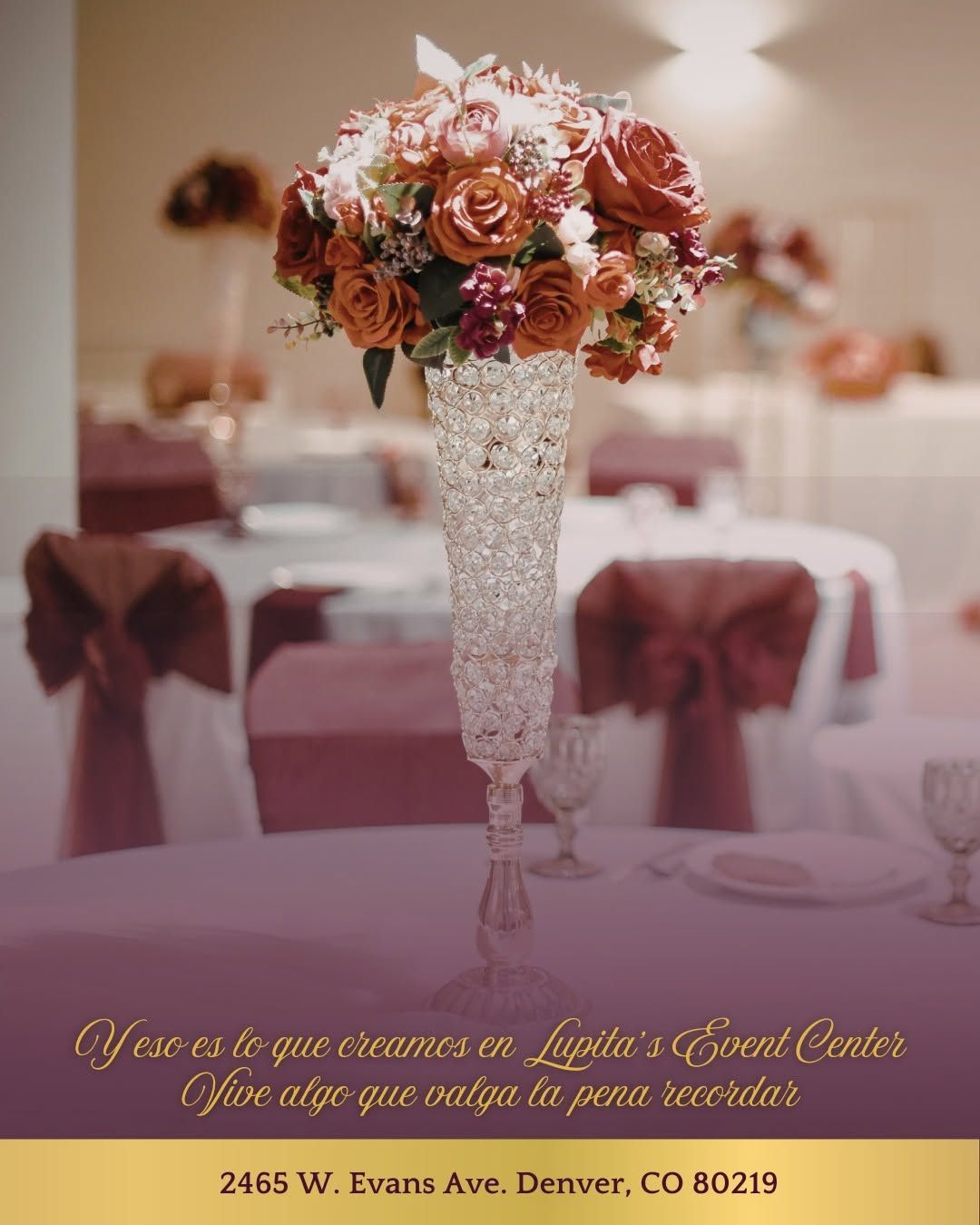 Tall crystal vase centerpiece with pink and peach flowers on a decorated reception table