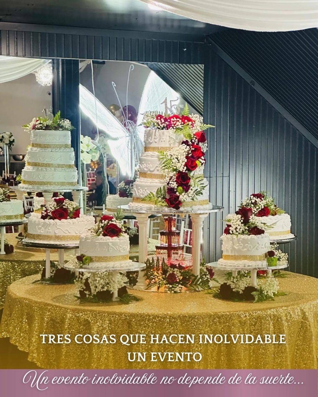 Wedding cake display with white tiered cakes, red and pink flowers, and gold table decor under a canopy