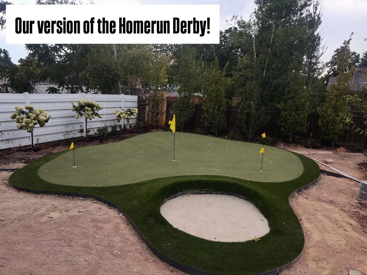 Mini-golf hole with green turf, sand bunker, and yellow flag in a backyard course