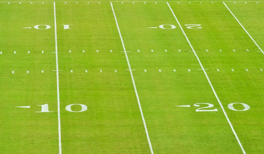 Green football field with white yard lines and the 10 and 20 markers visible