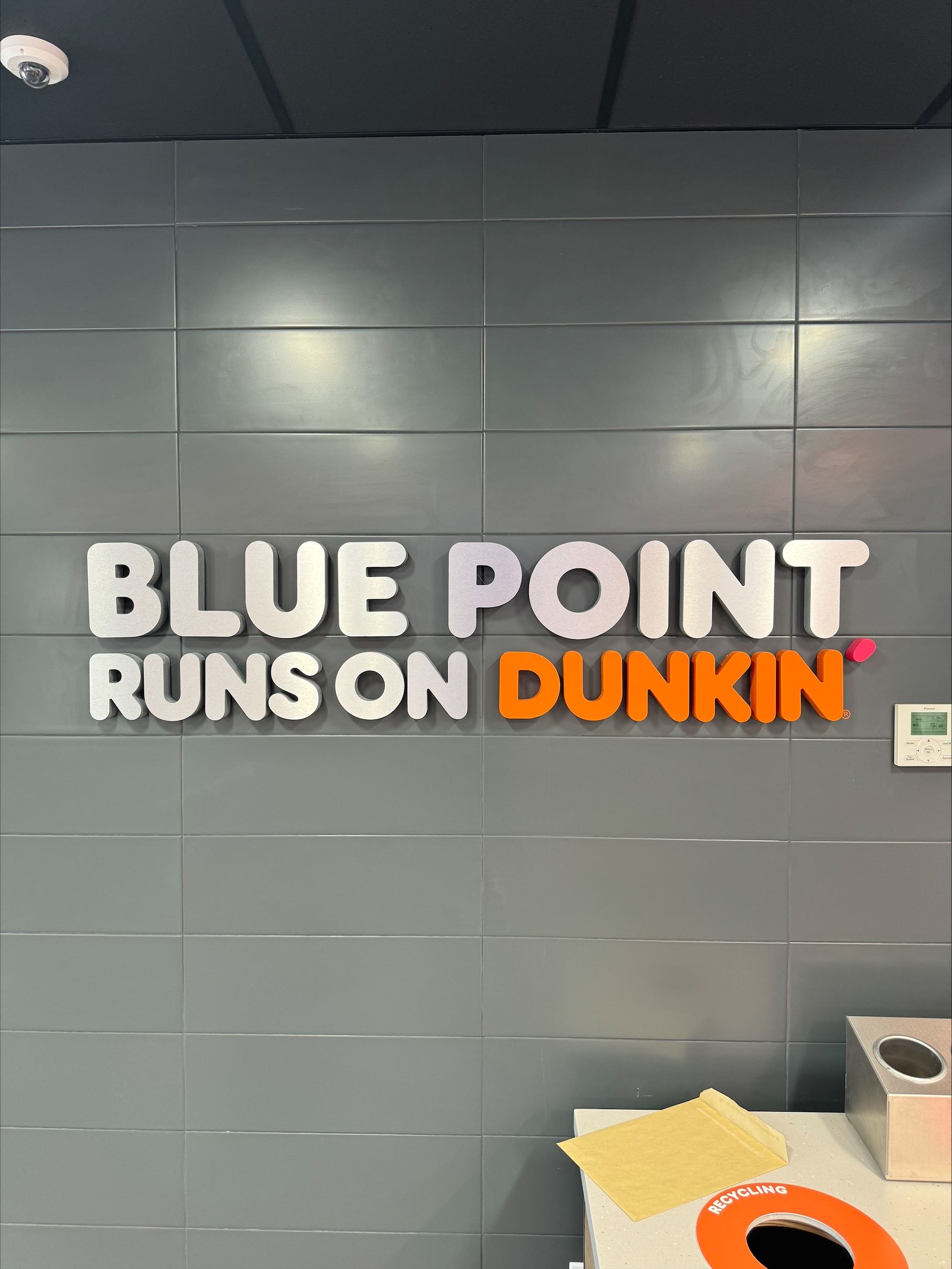 A sign that says blue point runs on Dunkin