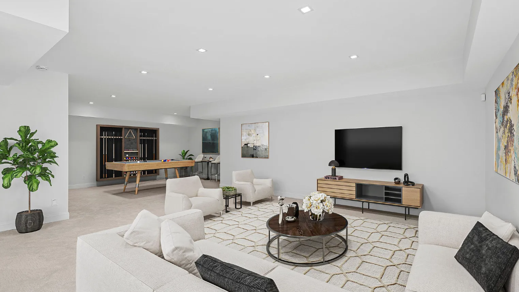 A living room with a couch, chairs, a table and a television.