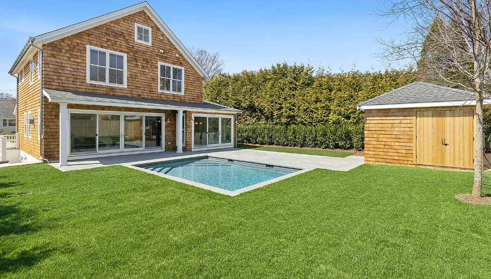 A large house with a large swimming pool in the backyard.