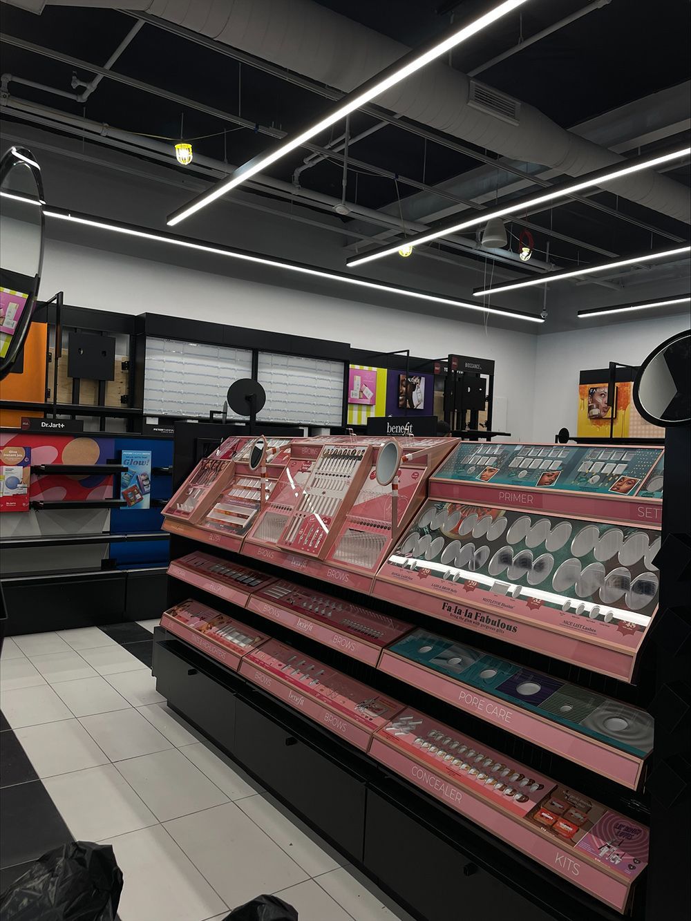 A person is standing in front of a shelf in a store.