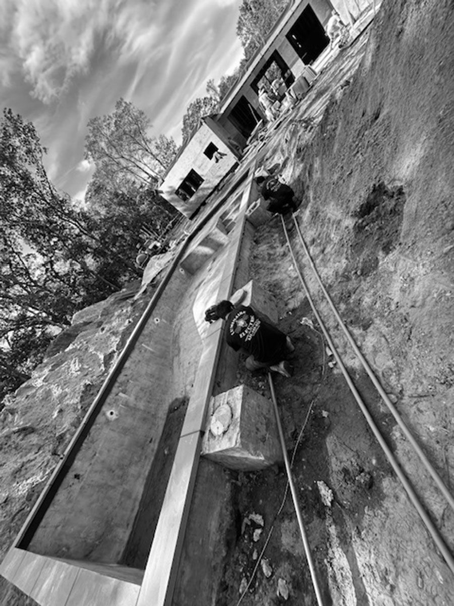 Forklift unloading large, industrial units at a loading dock