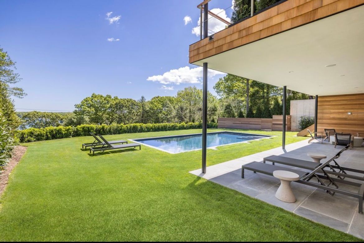 The backyard of a house with a large swimming pool