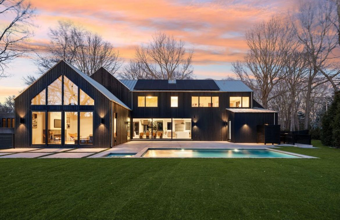 A large house with a swimming pool in the backyard